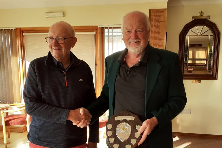 Iori Jones, president of the Borth and Ynyslas club, presenting the shield to Dafydd Raw Rees