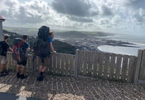 Folk duo hit halfway point of coast path walk in Ceredigion