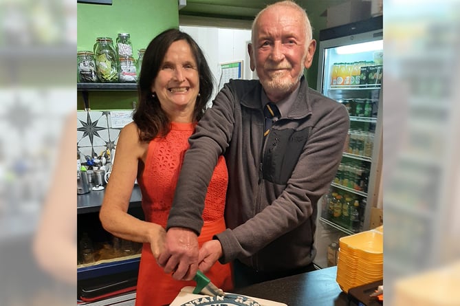 Team secretary Siân Campion cuts the cake with team chair and longest serving member Dave Williams who joined the team in 1974