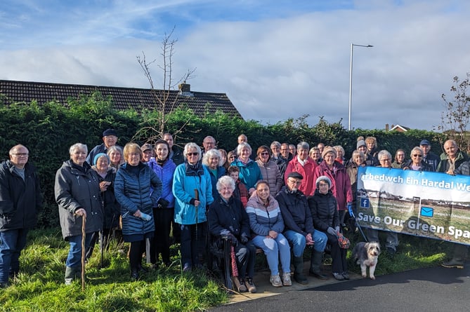 Residents gather to protest over plans to refuse a village green application at Erw Goch field