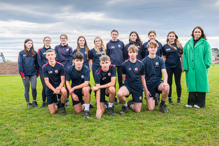 Ysgol Syr Hugh Owen pupils with Cllr Beca Brown, Cyngor Gwynedd Cabinet Member for Education near the site of the new 3G pitch in Caernarfon