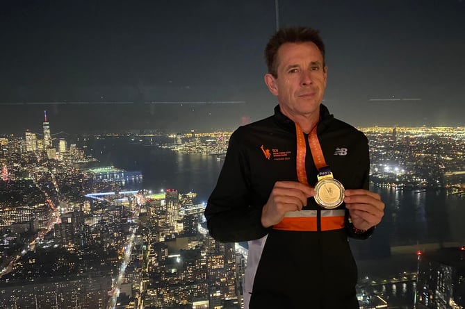 Paul Williams celebrating with his medal in New York