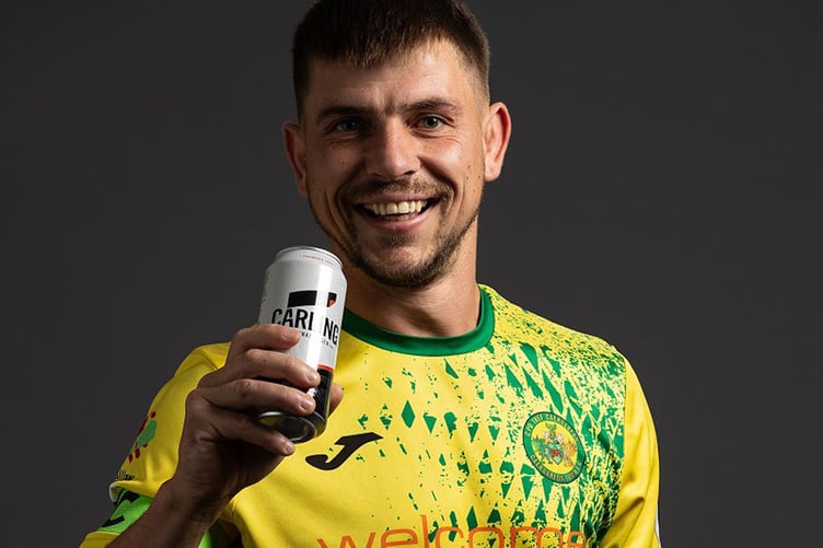 Caernarfon Town’s Darren Thomas enjoys a Carling
