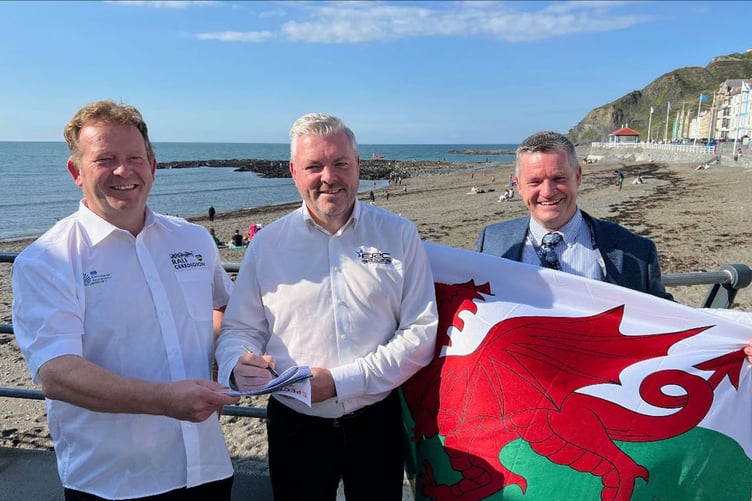 Rali Ceredigion commercial manager, Charlie Jukes (left) with FIA European Rally Championship manager, Iain Campbell (centre) and leader of Ceredigion County Council, Cllr Bryan Davies, affirming the new association on Aber Promenade