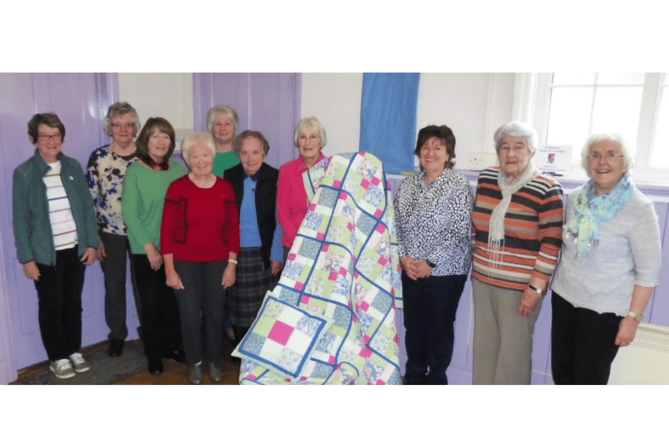 Llandre Craft group and the quilt they have donated to HAHAV