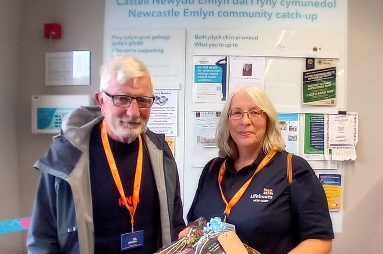Joanne and Tim receiving the hamper for the New Quay RNLI Christmas Fayre