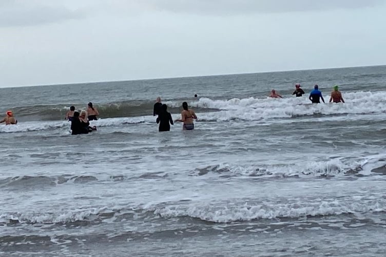 The team raised money after swimming in icy conditions