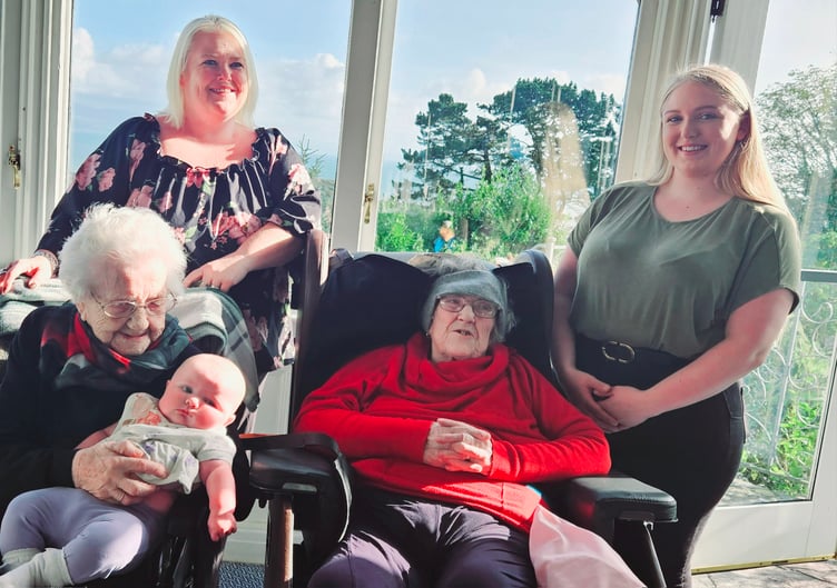 All five generations pose for a family picture at Beti’s birthday, and, below, the picture of their hands