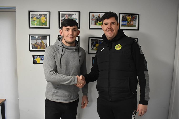 Town manager Richard Davies welcomes Morgan Owen to the club