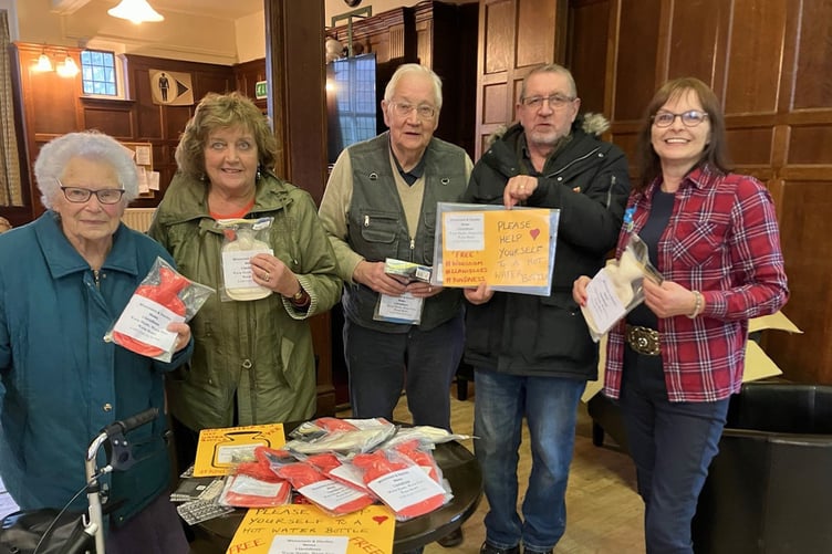 Llandinam Group from Alzheimer’s Society receiving the hot water bottles from Trudy Davies, Woosnam & Davies News