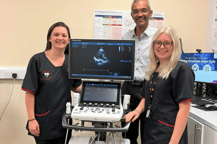 Pictured, left to right, with the cardiac ultrasound machine: Ceris Jones, Cardiac Physiologist; Dr Kevin Joseph, Locum Consultant Cardiologist; Emily Woodward, Cardiac Physiologist/Trainee Echocardiographer