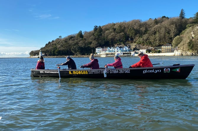 Porthmadog rowers in one of their Celtic Long Boats make their way past Portmeirion