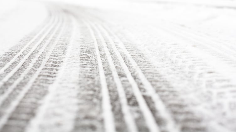 Wheel tracks on the winter road covered with snow