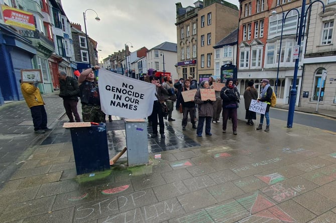 Over a dozen protestors turned out last minute to stage a demonstration on a main Aberystwyth street