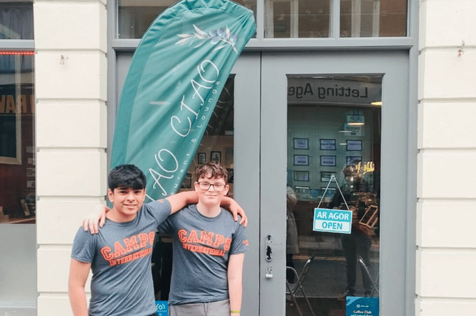 Penglais school children Callum Griffiths and Pranav Krishna stand outside Ciao Ciao, Aberystwyth, where they will be hosting a fundraiser to help them go on an expedition to Kenya