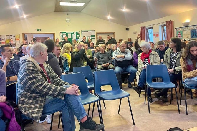 Concerned residents pack into a meeting to discuss their worries about pylon plan