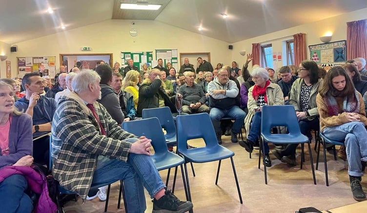 Concerned residents pack into a meeting to discuss their worries about pylon plan