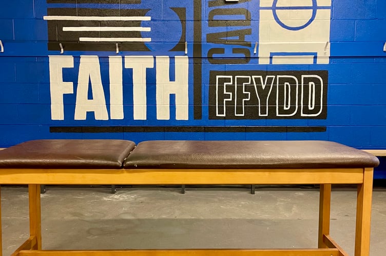 A mural painted by Coleg Menai art students in the home dressing room at Nantporth Stadium