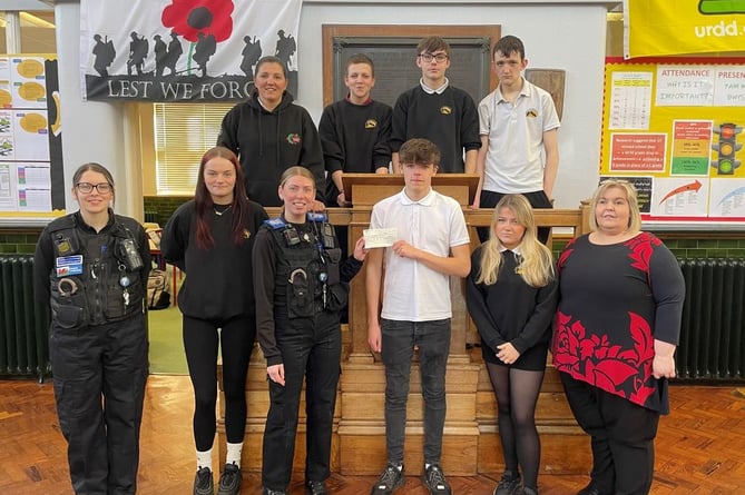 PCSO'S Shannon and Shana from Gwynedd South Neighbourhood Policing Team present a cheque to Youth Support Worker Jo Edwards and Ysgol Uwchradd Tywyn