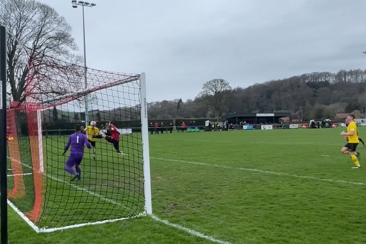 Porthmadog's Zak Pike direct an effort on goal