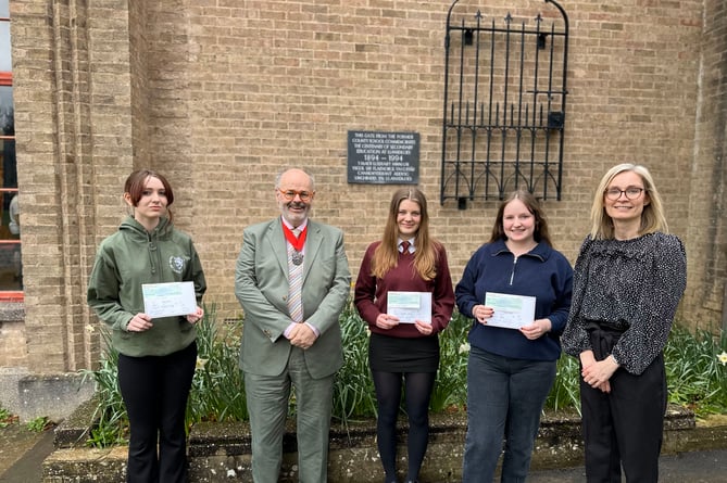 Pupils at Ysgol Uwchradd Llanidloes High School accepting their certificates and cheques from the Montgomeryshire Society yearly art competition
