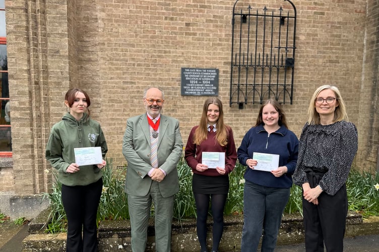 Pupils at Ysgol Uwchradd Llanidloes High School accepting their certificates and cheques from the Montgomeryshire Society yearly art competition