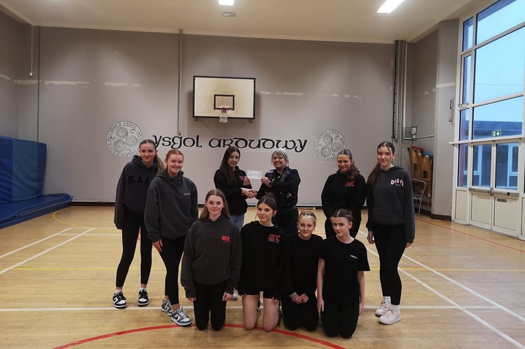 DDC Street Dance Group receive a cheque from Barmouth PCSO's Elliw and Gill