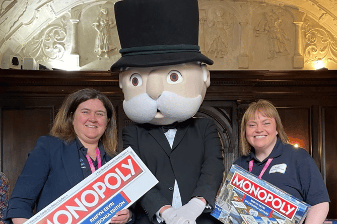 Head of Care at Ty Gobaith, Angharad Davies, Mr Monopoly, and Deputy Head of Care, Kate Jones