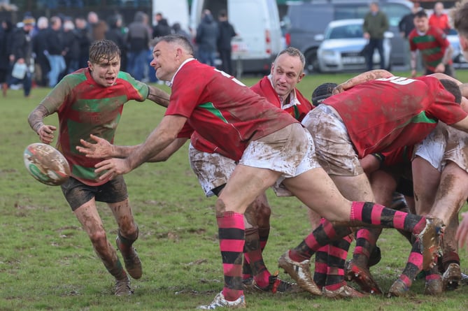 Wales legend Mike Phillips gets the ball away for the president's team against Llanybydder