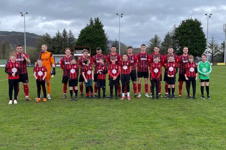 The Porthmadog team line up with the club's under 11s before kick off