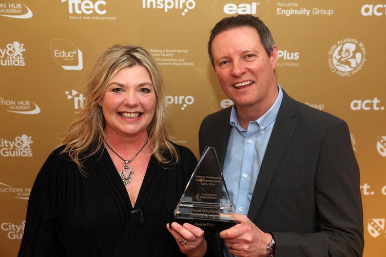 Needle Rock owner Dr Ali J. Wright receives the Small Employer of the Year award from Richard Spear, managing director of ACT Limited, sponsor.