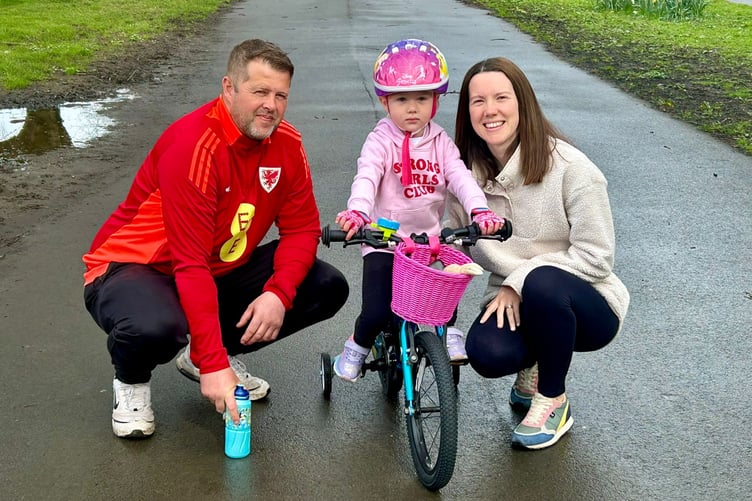 Pixie Roberts on her brand new wheels with her parents Rhydian and Sam