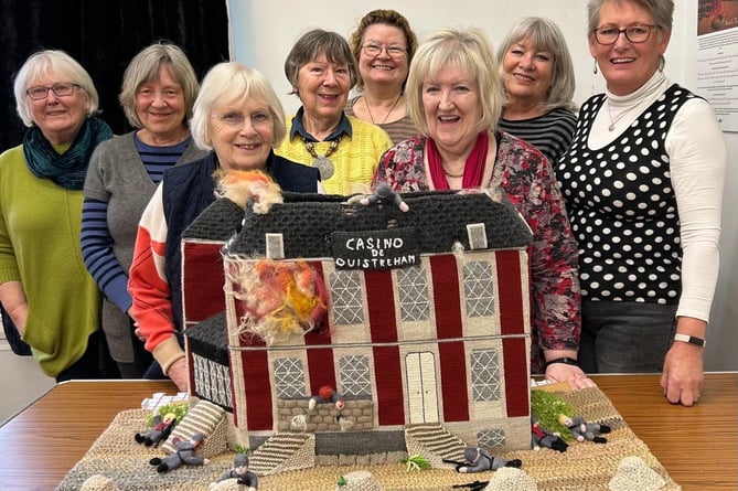Some of the women involved in creating the casino panel with the finished product