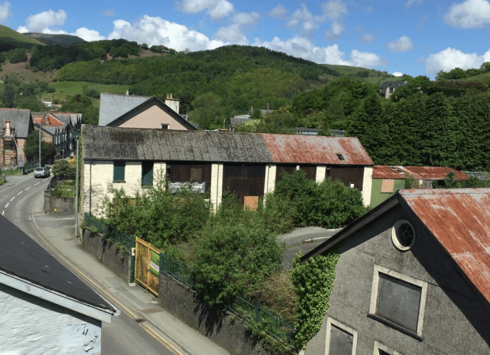 The former Travis Perkins building yard on Heol Y Doll contains two buildings and gated yard