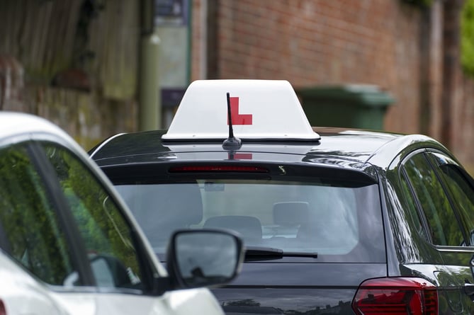 A learner driver drives down a street in Winchester, Hampshire. Picture date: Thursday May 20, 2021.