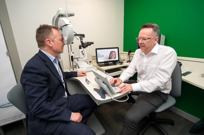 12.04.24 - Russell George MS and shadow health minister visits Specsavers in Newtown, Powys - Russell George MS has his eyes tested by store director David Dunlop