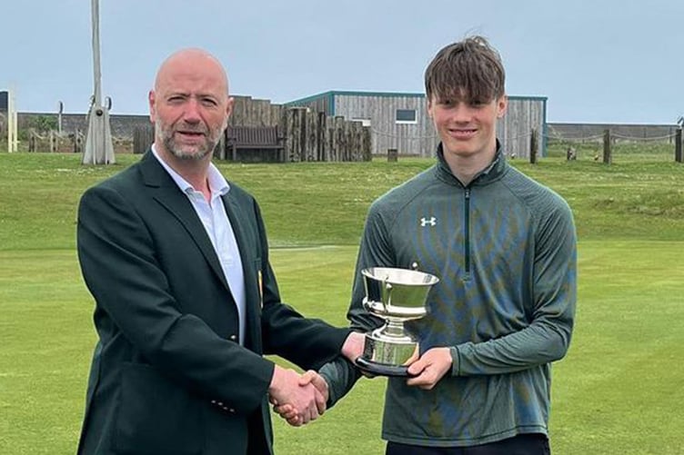 Dion Regan is presented with the cup