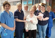 Church present baby unit with cheque to buy cot