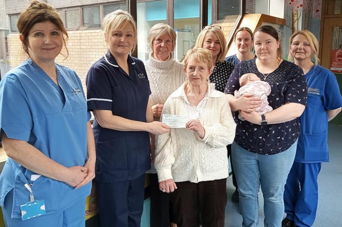 Children’s Ministry volunteers Nesta Hughes (front centre), Angela Swann (rear centre),Yvonne Furber with baby Rhiannon, Ward Sister Suzanne Roberts and staff from the unit