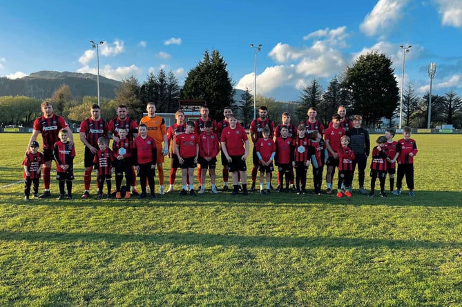 The Porthmadog first team with junior team players before kick-off against Holywell