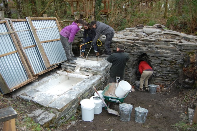 CAT students learning how to create lime in a traditional lime kiln on-site, one of only two in Wales