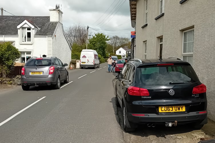 Lloyd Osborne and his sons trying to walk to school on the pavementless road in Llanrhystud