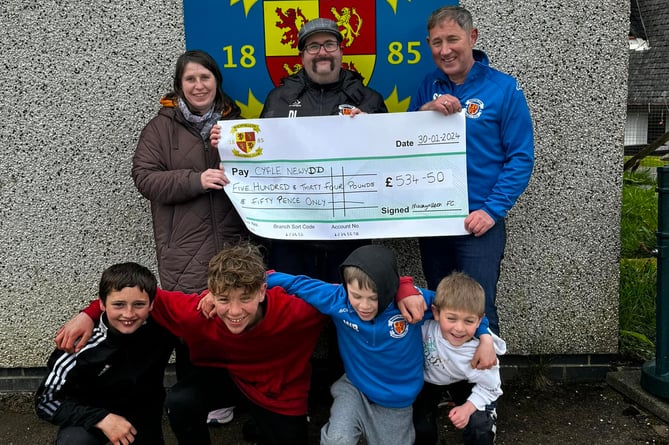 Machynlleth have handed a cheque to Cyfle Newydd for the money raised during a friendly against Corris United