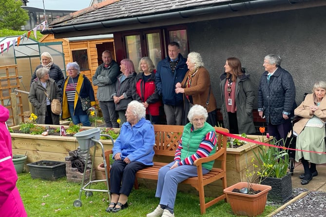 The residents gathered outside for the official opening of the new garden