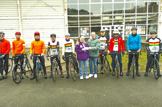 Ystwyth Cycling Club members had over the cheque to Papyrus