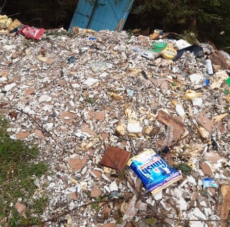 A passer-by reported the huge mound of trash left in a forest near Forge, Machynlleth