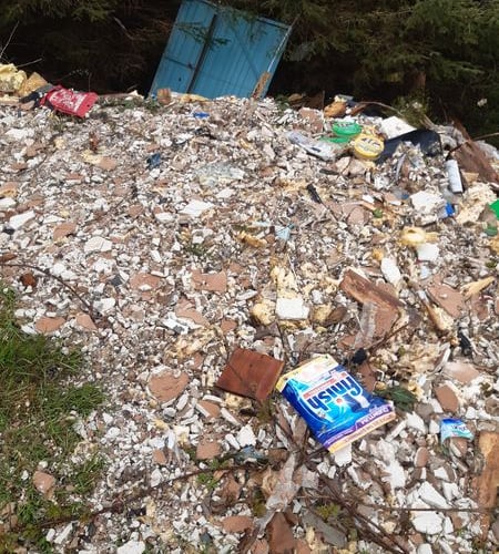 A passer-by reported the huge mound of trash left in a forest near Forge, Machynlleth