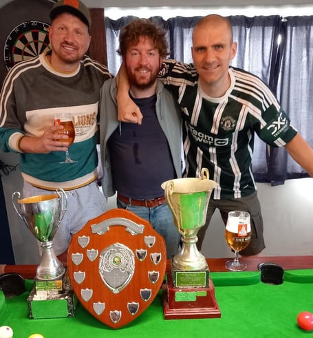 Three of the Royal A team with main trophies for KO Cup, Shield and League