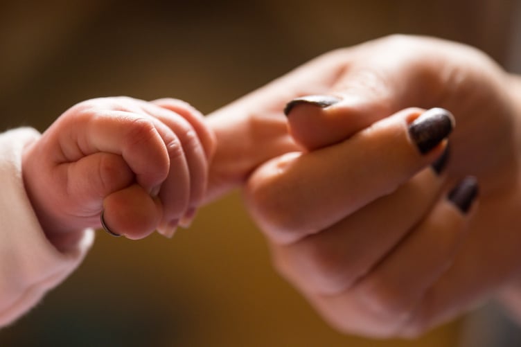 Undated file photo of a new baby holding the finger of its mother. A treatment for a rare genetic condition that usually kills babies before they turn one is to be made available in England in a first for the NHS. It is hoped the move will help save the lives of babies and toddlers born with Wolman disease, a type of lysosomal acid lipase deficiency that occurs in one in every 350,000 births. Issue date: Monday November 27, 2023.