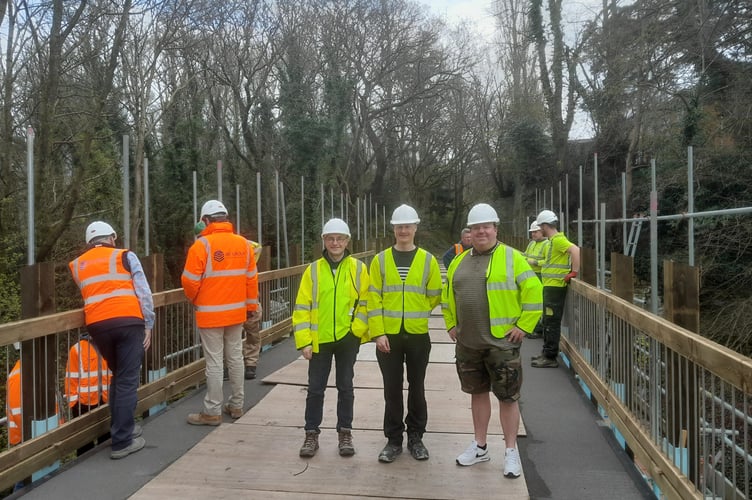 Councillor Dafydd Meurig, Cabinet Member for the Environment Department, Iwan ap Trefor from Gwynedd Council's Environment Department, and local councillor Nigel Pickavance, during the replacement work. Photo: Gwynedd Council